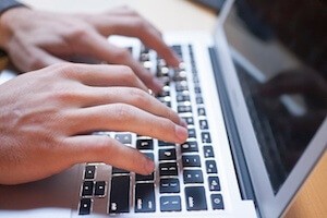 Hands Typing on Computer